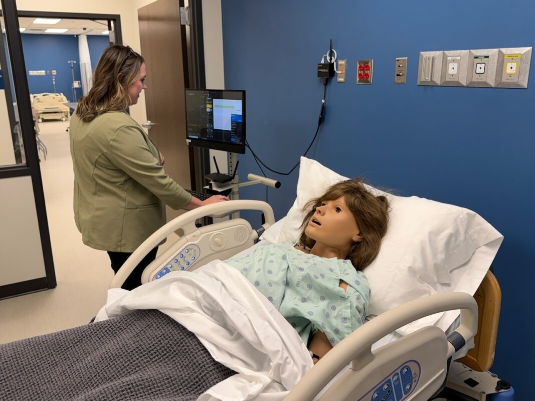 picture of ASU Three Rivers faculty member in new nursing building with a training mannequin