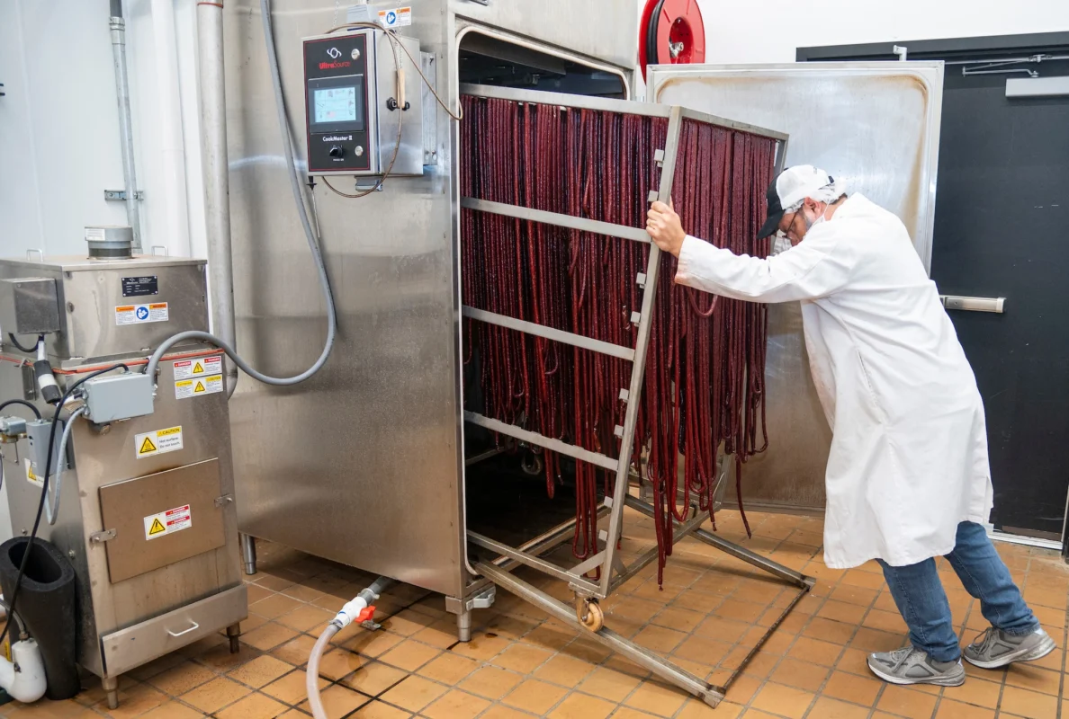 Picture of Corey Readnour processing snack sticks in the College of Agriculture Meat Market at Arkansas State University.