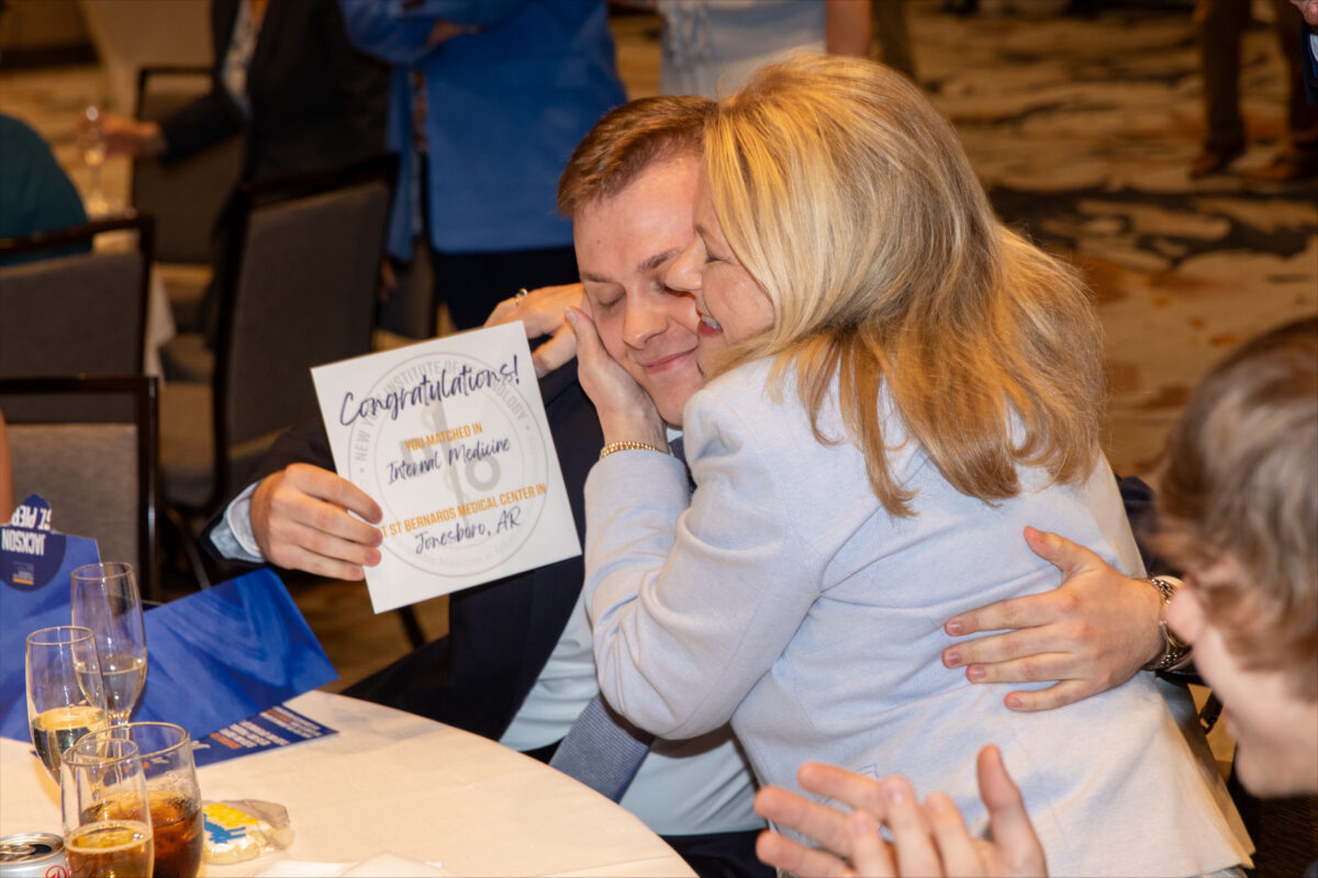 Picture of Jackson St. Pierre, a fourth-year medical student at NYIT College of Osteopathic Medicine at Arkansas State University, hugging his mother, Angel, after learning that he matched into the internal medicine residency program at St. Bernards Medical Center in Jonesboro.