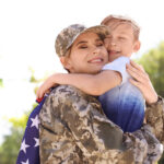 picture of American soldier with her son outdoors.