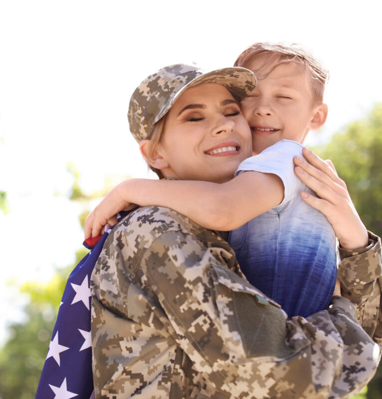picture of American soldier with her son outdoors.
