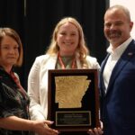 A-State Chancellor Todd Shields stands with two women representing the Arkansas Rural Development Commission while receiving Rural Advocate of the Year Award.