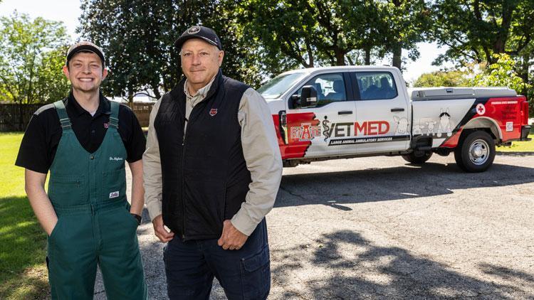 Dr. Trey Neyland and Dr. Scott Reiners stand in front of the ambulatory vehicle.
