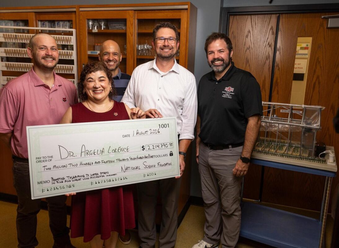 Dr. Argelia Lorence, with her "big check," is shown with (from left) Dr. Jacob Manlove, associate professor of agricultural economics; Dr. Reinier Gesto-Borroto, ABI phenomics core manager; Dr. Travis Marsico, vice provost for research, innovation and discovery; and R. Shea Harris, ABI outreach and information technology manager. Not pictured is co-project lead, Dr. Scott Mangan, associate professor of ecology.