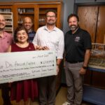 Dr. Argelia Lorence, with her "big check," is shown with (from left) Dr. Jacob Manlove, associate professor of agricultural economics; Dr. Reinier Gesto-Borroto, ABI phenomics core manager; Dr. Travis Marsico, vice provost for research, innovation and discovery; and R. Shea Harris, ABI outreach and information technology manager. Not pictured is co-project lead, Dr. Scott Mangan, associate professor of ecology.